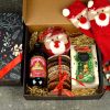 Coș cadou corporate de Crăciun cu dulciuri, turtă dulce și șosete festive.